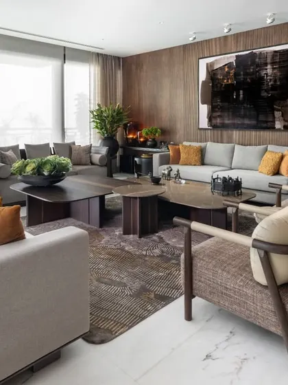 This living room is a masterclass in quiet confidence, where a neutral palette is enlivened by pops of mustard yellow and rich textures. The custom ribbon veneer wall and a powerful abstract painting by Kingsley Gunatillake create a sophisticated backdrop for our bespoke Koko furniture.