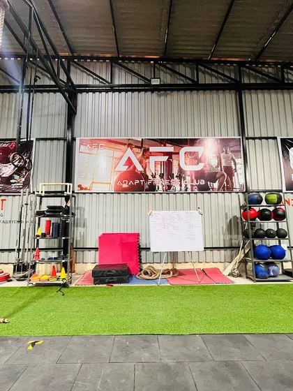 A view of our functional training area, complete with a climbing rope, medicine balls, and turf strip for sled pushes and agility drills.