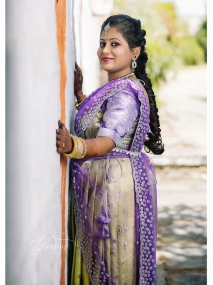 For this engagement look, we paired a traditional half-saree with a beautiful side-swept braid. The makeup was kept fresh and radiant to complement the vibrant colours of her outfit.
