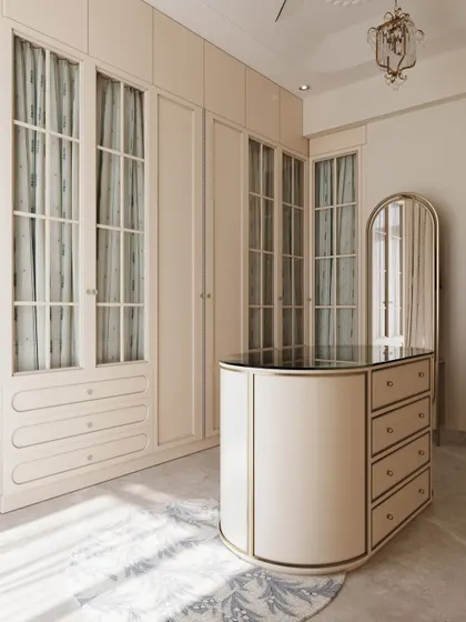 The curved lines of the central island and mirror contrast beautifully with the linear wardrobes, creating a dynamic yet harmonious space.