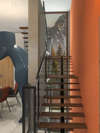 A view of the stylish staircase in the Nainital home, with an industrial metal railing and wooden steps, leading up from the dining area.