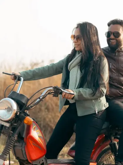 A fun, role-reversal moment with her taking the driver's seat of the moped. Their smiles show the playful, joyful dynamic of their relationship.