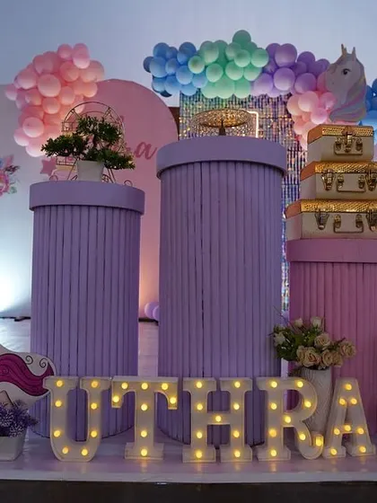 A detailed look at the props for a unicorn-themed party, including custom-printed plinths and marquee letters.