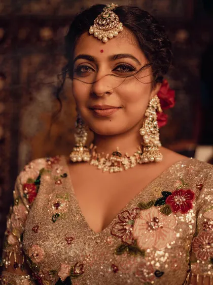 A close-up portrait of actress Leona Lishoy for the 'Zamani' music video project. I styled her in a heavily sequined and embroidered lehenga with traditional pearl and kundan jewelry to create a classic, romantic bridal look.