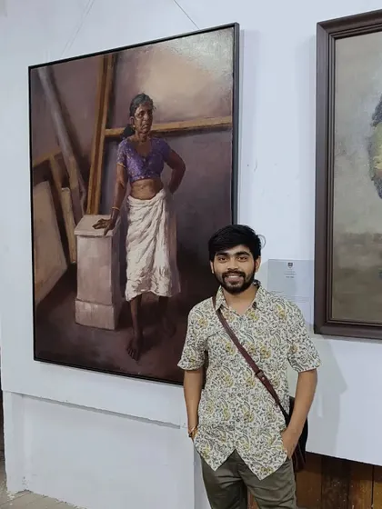 A solo shot of me with my painting "Amma" at the exhibition.