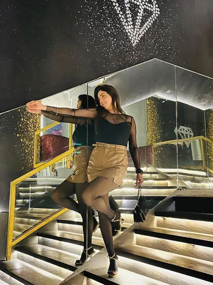 Another pose from the mirrored staircase, showing off the edgy yet chic outfit.