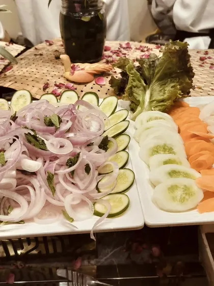 A simple yet elegant display of sliced onions, cucumbers, carrots, and tomatoes, a staple at any Indian feast.