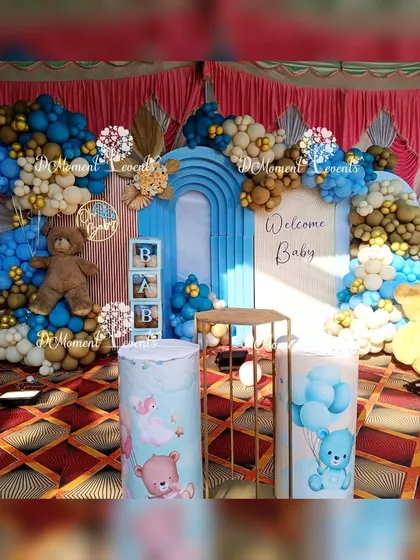 A close-up of the teddy bear baby welcome stage, showing the "Oh Baby" sign and themed pedestals.