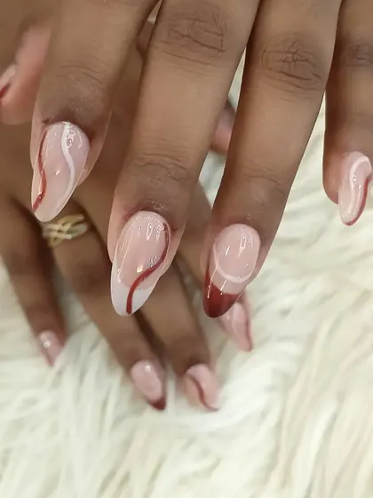 Another angle of the elegant red and white abstract swirl nails.
