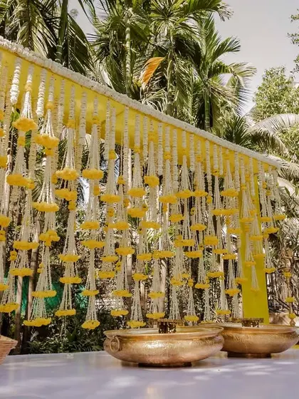 The full view of the Haldi decor backdrop, showcasing the intricate floral hangings.