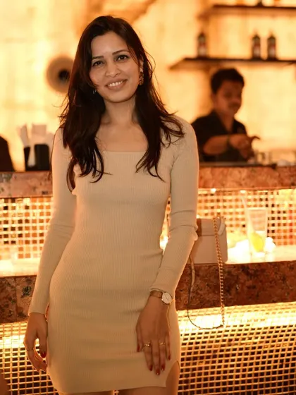 A duplicate shot of the guest in the chic beige dress.