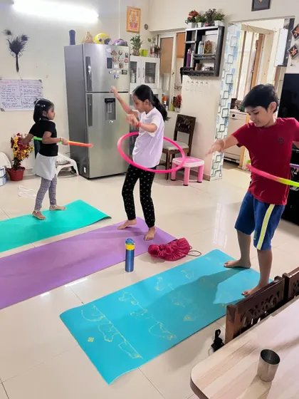 A duplicate of image 283, capturing the joy and energy of a kids' fitness class with hula hoops.