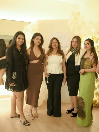 Our members dressed up and brought the best energy to our first anniversary party. Here's a group enjoying the evening against our celebration backdrop.