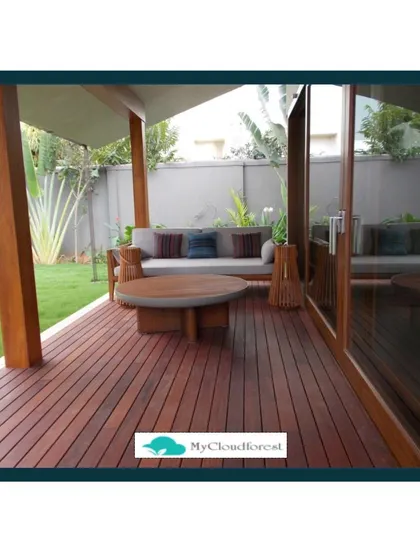 The quality of the flooring sets the foundation for the entire space. This covered patio features stunning Ipe wood decking, known for its durability and deep reddish-brown color. It provides a warm, natural, and luxurious base for the outdoor lounge area.