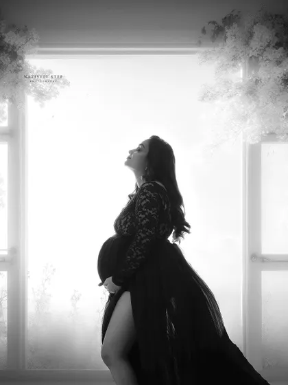 A stunning black and white silhouette against a bright window. The lace gown and the dramatic lighting create a breathtaking and artistic portrait.