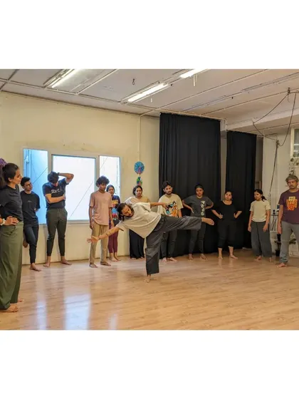An instructor demonstrates a move while students watch, ready to try it themselves.