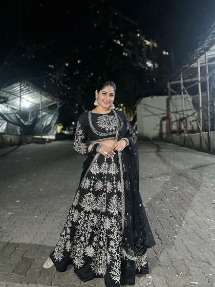 Another beautiful shot of Donam Bajwa enjoying her festive look. The black and silver combination is a timeless choice for any evening celebration.