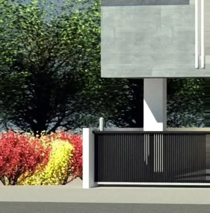 A modern front gate and boundary wall design featuring colorful, low-maintenance shrubs. This element of site design provides security while contributing to the property's overall curb appeal and landscape theme.
