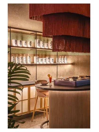 A wider shot of the bar area, where the custom-painted pots are displayed on illuminated shelves, becoming a central part of the decor.