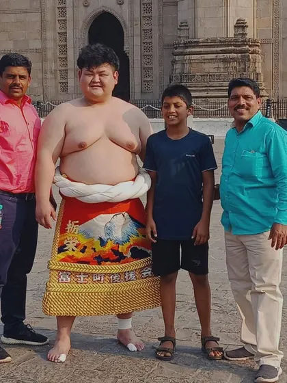 Wrestling connects people across cultures. Here I am with one of our students meeting a Japanese sumo wrestler at the Gateway of India during a cultural exchange.
