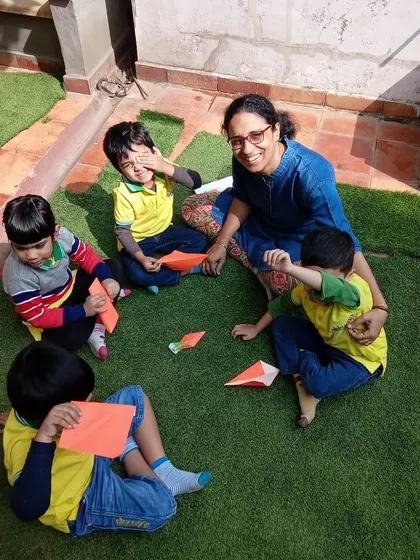Soaking up some Vitamin D while learning the art of origami. This outdoor craft session combines the benefits of fresh air with an activity that enhances concentration and spatial reasoning.