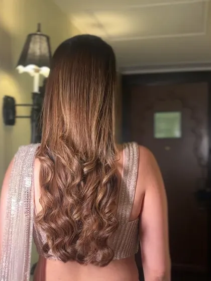 This sleek tuck with waves is a popular choice for a sophisticated look. The hair is kept smooth and away from the face on one side, while the other side features a cascade of soft waves.