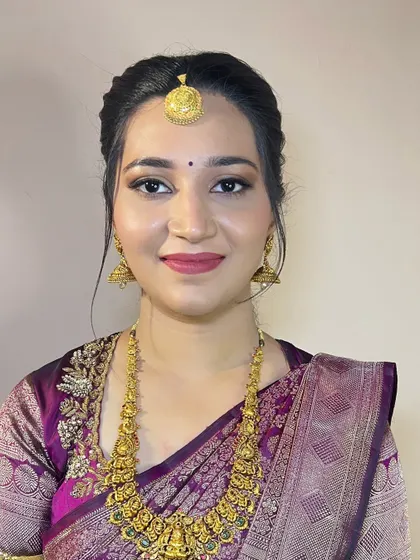 A close-up portrait of this lovely client. The makeup is soft and natural, with a focus on enhancing her features.