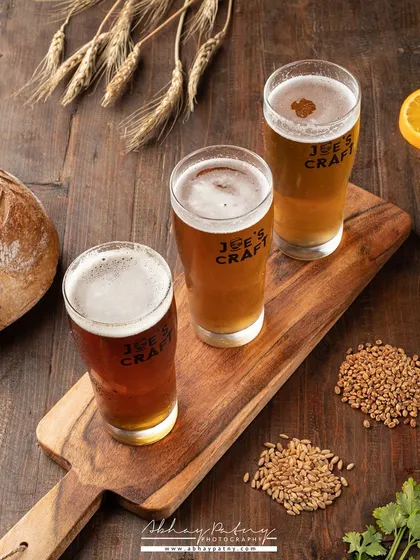 This image showcases a flight of different beers. It's an effective way for a brewery or bar to show their range and encourage customers to try multiple varieties.