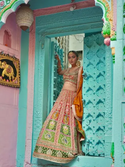A vision of grace, draped in heritage. This multi-colored lehenga with panels of green, pink, and orange is a celebration of traditional Indian artistry.
