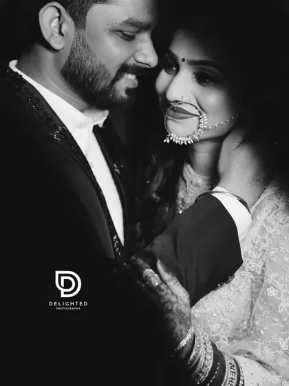 A dramatic black and white close-up capturing the intimacy and emotion between the couple, highlighting the bride's traditional nose ring and the couple's deep connection.