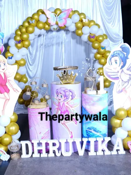 A golden fairy tale theme with white and gold balloons and cute fairy cutouts.