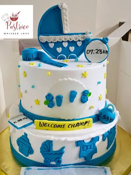 A two-tiered welcome cake for a baby boy, personalized with his birth time, date, and weight.