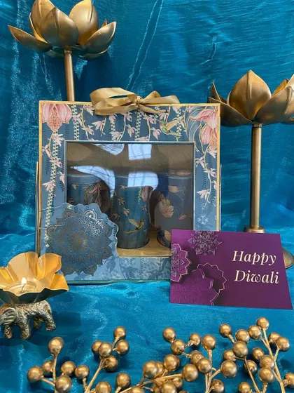 A stunning teal and gold floral box containing three decorated glass jars. This hamper is perfect for gifting sweets or dry fruits with a touch of festive elegance.