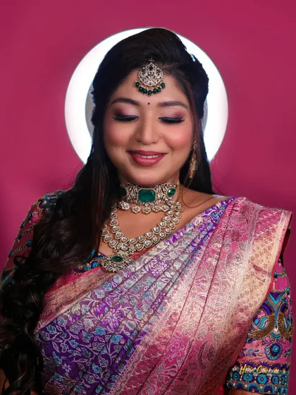 A beautiful bridal portrait using a ring light for a soft, flattering glow against a solid pink background.