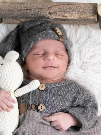 Holding a tiny teddy bear, this newborn is the picture of innocence. We have a variety of safe, soft props for your baby to hold or snuggle with during the session.