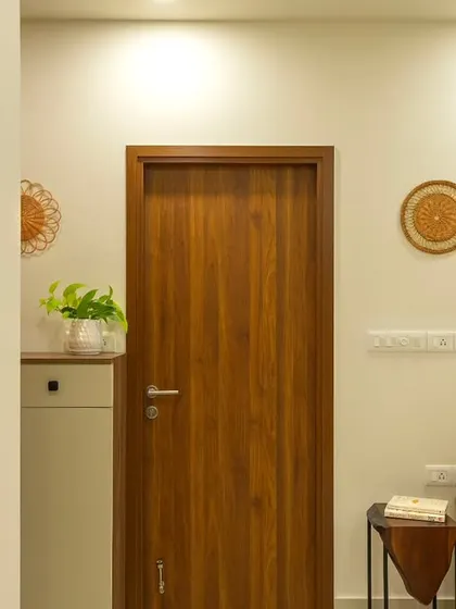 The entryway of 'Bohemian Bliss' sets a warm, rustic tone with natural wood, woven wall decor, and a touch of greenery.
