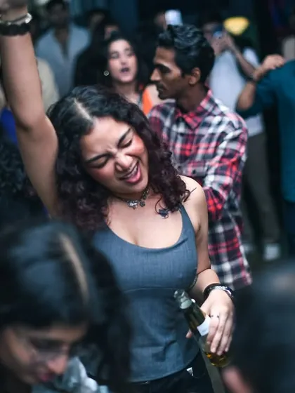 A shot of someone singing their heart out on the dancefloor. Pure passion.