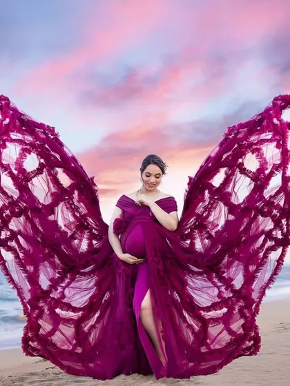 A fantasy edit with butterfly wings and a dramatic sunset sky, turning a beach photo into a magical piece of art.