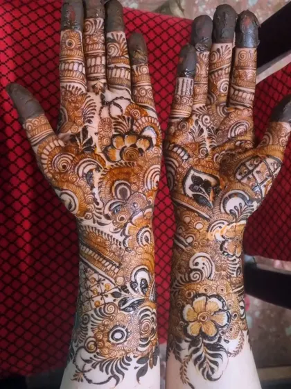 Another example of a rich Indo-Arabic design with full fingertip coverage. The pattern is a beautiful chaos of florals, leaves, and traditional Indian motifs.