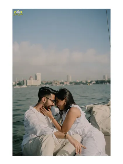A quiet, intimate moment on the water. The Mumbai cityscape provides a stunning backdrop, but their connection is the real focus.