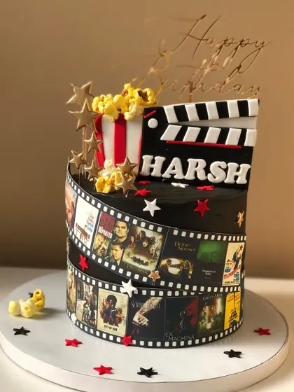 A cake for a movie buff, decorated with a film reel of favorite movie posters, popcorn, and a clapperboard.