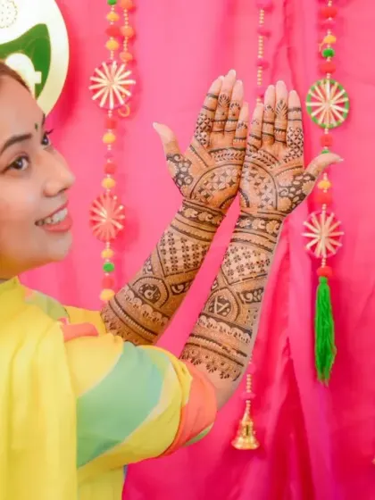 A happy bride showing off her completed mehandi. Seeing our clients smile is the best part of our job.
