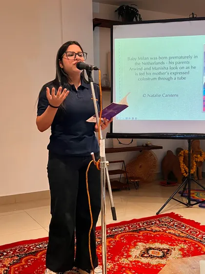 A participant sharing her thoughts during the discussion on breastfeeding. We aim to create interactive events where the audience can actively engage with the topic.