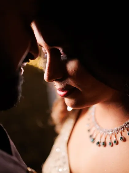 An intimate and moody close-up from an engagement session. The dramatic lighting highlights the couple's connection and the quiet intensity of their bond as they begin their journey to forever.