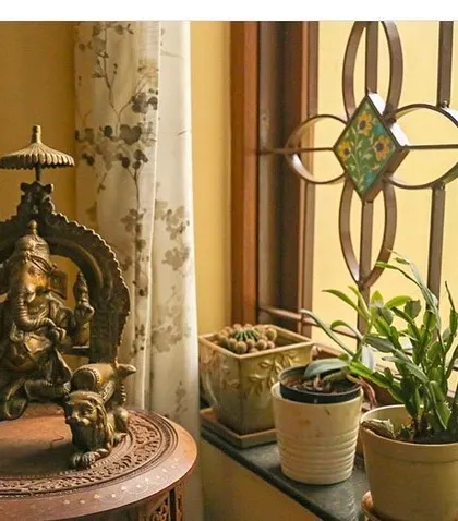 A quiet corner in the Roopa Hariprasad Residence is dedicated to a traditional bronze Ganesha idol. Details like this, placed thoughtfully within the home, help to create a space that feels personal and spiritually grounded.