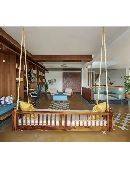 A closer look at the custom-designed swing and the integrated library shelving. Every element is designed to be functional, from the seating bench with storage to the dedicated workspace, creating a truly livable family area.