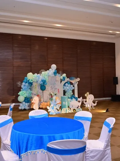 Another view of the party hall, showing the main decor setup in relation to the guest seating area.