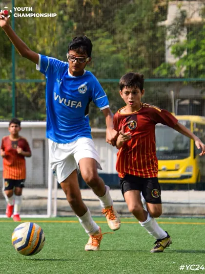 Defending with heart. Two players from opposing teams challenge for the ball in a competitive match.