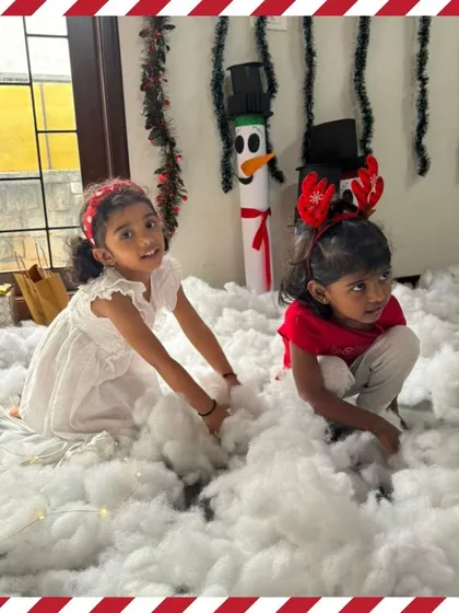 Two friends share a moment in our winter wonderland, complete with a snowman craft in the background.