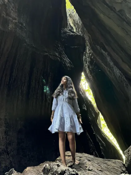 A trekker inside the stunning Yaana caves.
